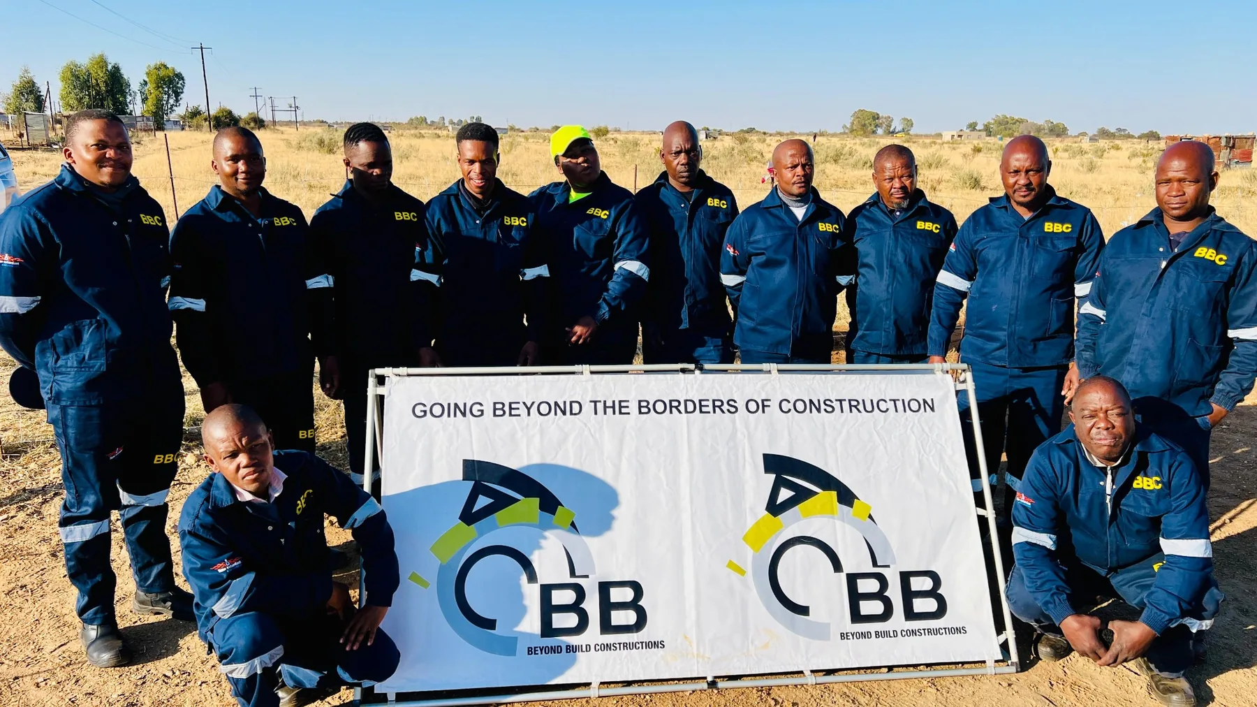 Beyond Build employees with company banner